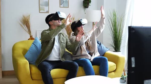 Couple Immersed in Virtual Reality Experience at Home