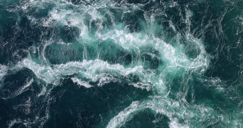 Blue waves of water of the river and the sea meet each other during high tide and low tide.