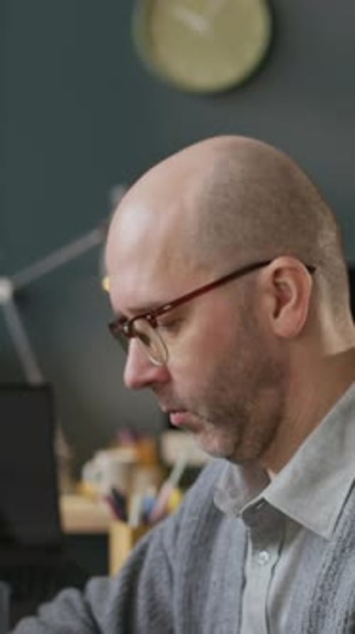 Vertical Portrait of Middle-Aged Male Programmer Working in Modern Office