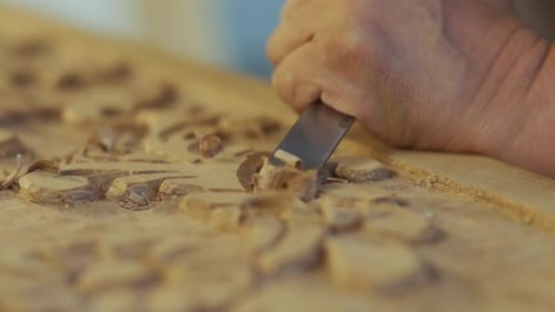 Close up carpenter's hands that work with cutter. carpenter shaping wood
