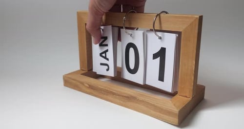 Hand Flips Calendar Page to January 1st