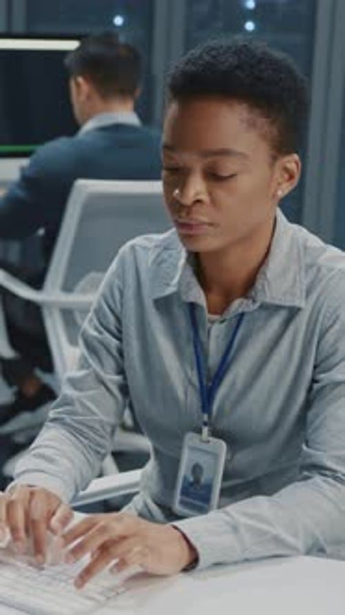 African American Young Female IT Administrator Cooperating in Office Multiethnic Professional Team