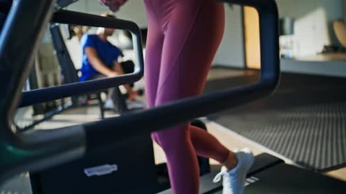 Woman Walking on Treadmill Exercising in a Gym