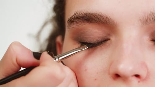 Makeup Artist Applying Eyeliner in Close Up Shot