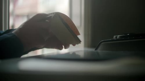 3D Engineer grabs a paper notebook at cowork space and starts drawing design writing during the day