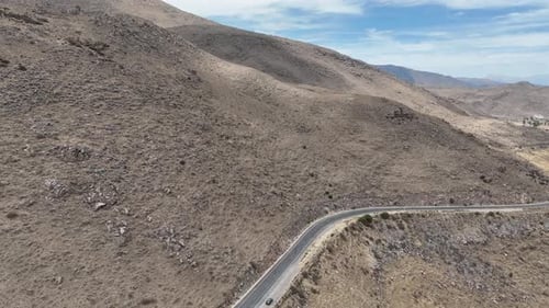 Aerial dolly shot from a mountain in peru south america with a country road and a beautiful view of