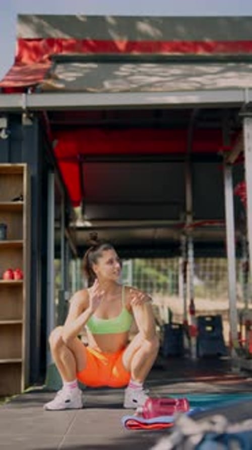 Young Adult Woman Stretching in Outdoor Gym