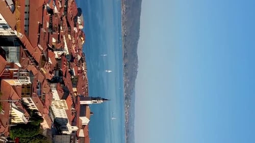 Aerial view of Lake Maggiore from Rocca of Arona with sailboat and church. VERTICAL format