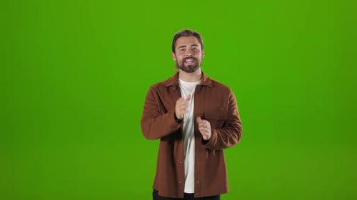 Confident Man Talking and Gesturing Over Green Background