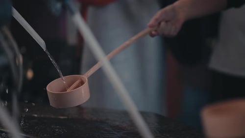 Chozuya - Worshipper Use A Wooden Ladle, Hishaku To Pour Water Over Its Hands Inside A Pavilion At a