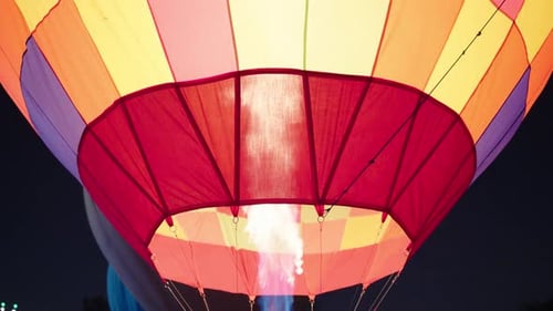 Colorful Hot Air Balloon Flame Illuminates Night Sky