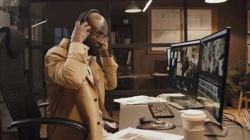 Young Adult Working at Computer with Dual Monitors