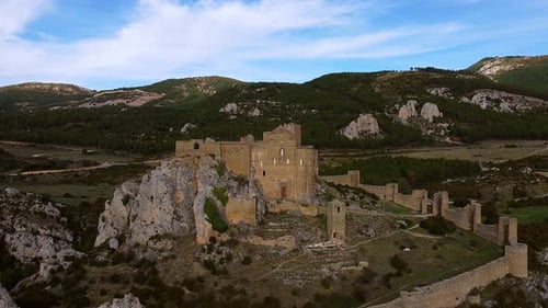 The Castle of Loarre With Mountain Background In Huesca Province, Aragon Spain. Aerial Pullback Shot