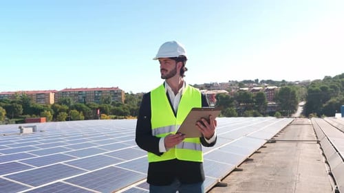 Solar Energy Engineer Inspecting Photovoltaic Panels on a Rooftop