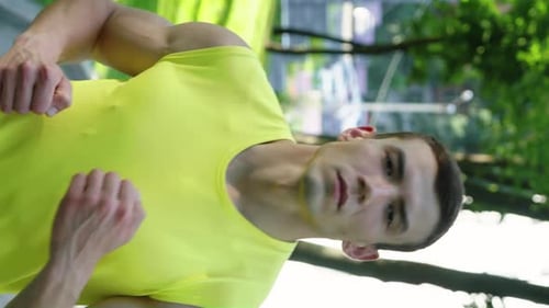 Vertical Screen Slow Motion Muscular Man Jogging in Park