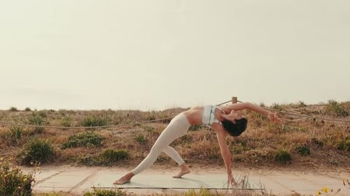 Woman Practicing Yoga Outdoors on the Beach