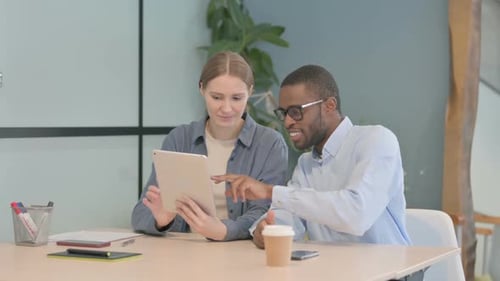 Multiethnic Young Business People Working on Tablet in Office