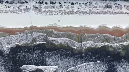 Man on snowy beach in winter at Baltic sea, Poland