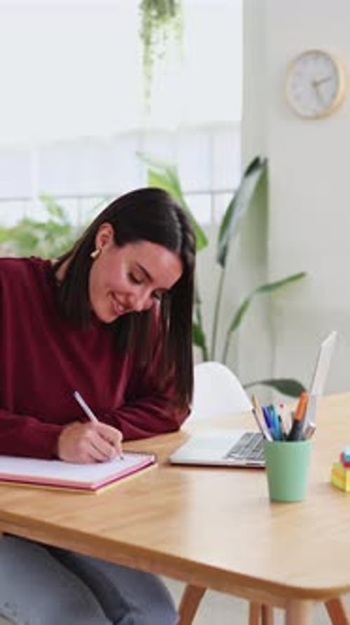 Young Woman Studying at Home with Laptop