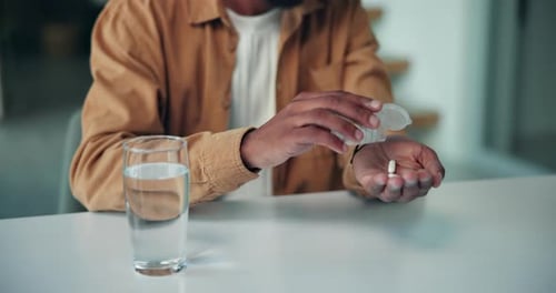 Adult Taking Pills with Water at Home