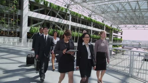 Business Team Walking Along Modern Office Building