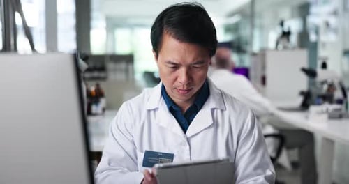 Scientist Works With Tablet in Modern Laboratory