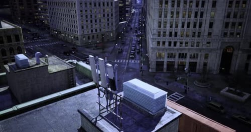 City Skyline at Night Featuring Rooftop Antennas in Urban Setting