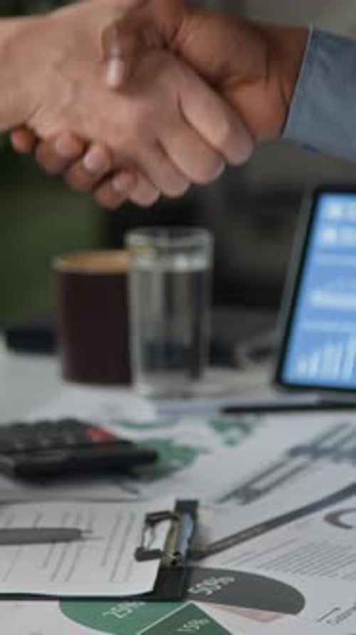 Two People Shake Hands Over Business Deal