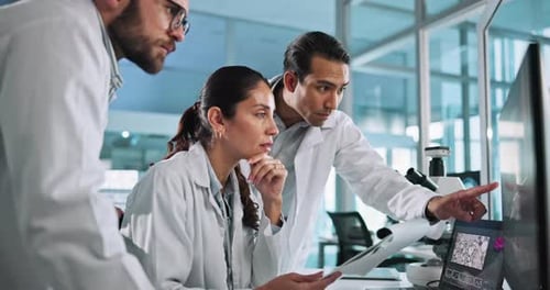 Scientists Analyzing Data in Modern Lab