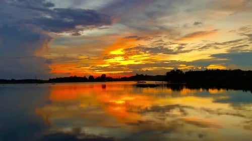 The beautiful sunset over the calm waters of the lake makes for a perfect view