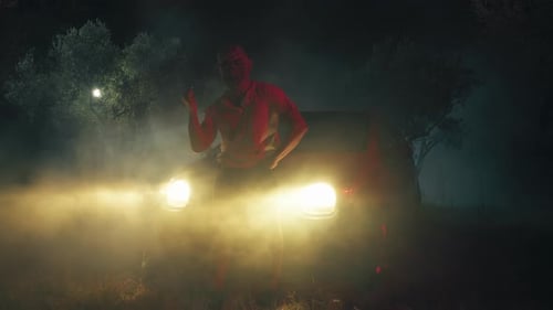 Masked Figure with Weapon in Eerie Night Setting