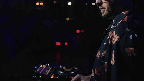 Cool DJ Playing Techno Music For Dancing Crowd In Nightclub Closeup View Of Hands On Controller