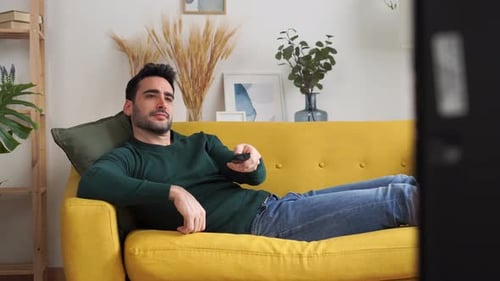 Man Relaxing and Laughing on Couch