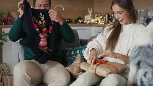 Couple Opening Gifts at Christmas at Home