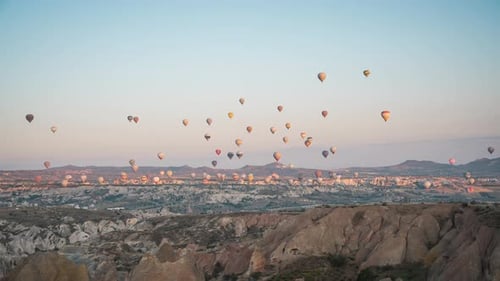 Hot air balloons rise over Cappadocia’s unique landscape during a calm sunrise timelapse