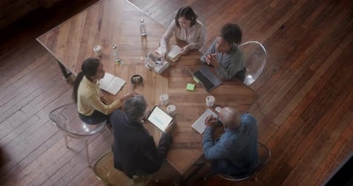 Overhead View on Business People in Meeting with Technology at Creative Office