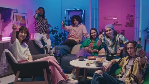 Friends Enjoying Drinks Together Indoors at Night