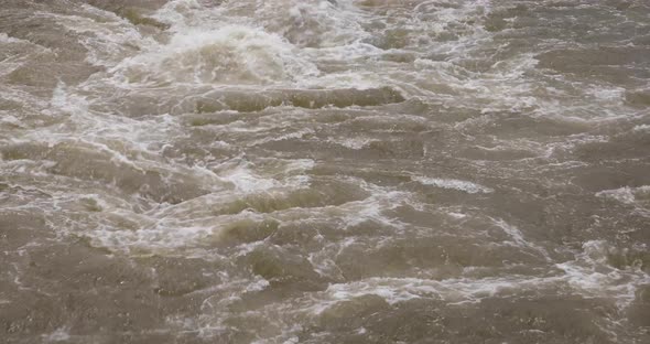 4K Close Up of Murky Water Raging with White Water from a Reservior ...