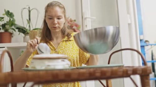 Young Woman Baking Cake in Bright Home Kitchen