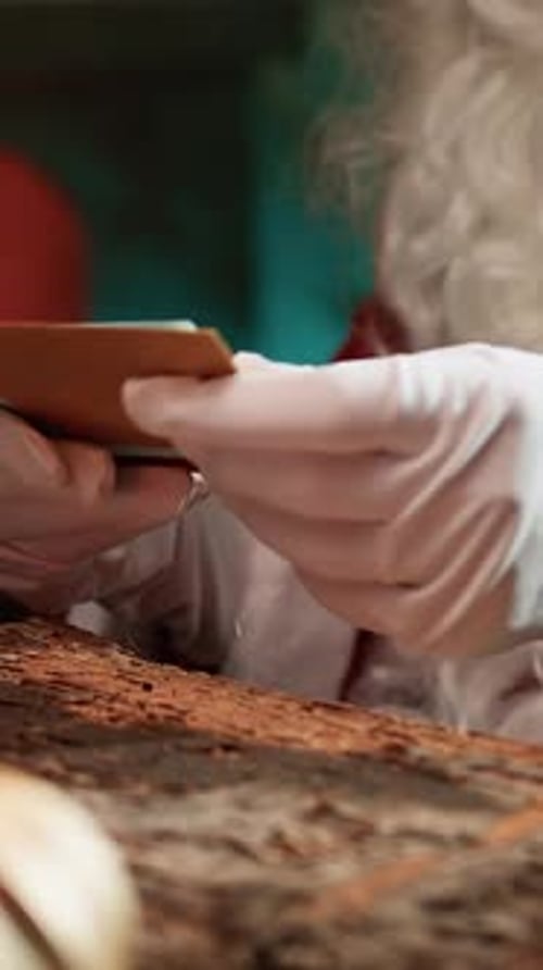 Gloved Hands Shuffling Holiday Envelopes Close Up