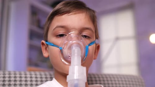Child Using Nebulizer Mask in a Home
