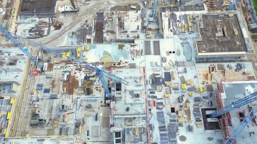 Aerial Bird Eye View Of a Construction Site Building Cranes Looking Down Industrial Machinery Area a