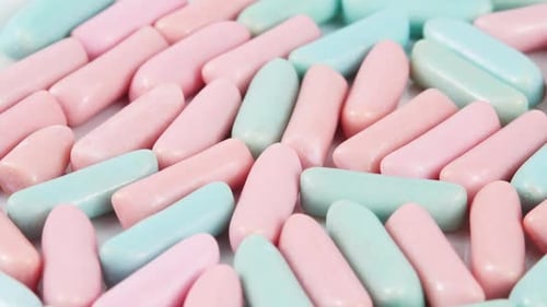 Multicolor Chewing Candies Rotating Background. Sweets Concept. Unhealthy Food. Bright Blue and Pink