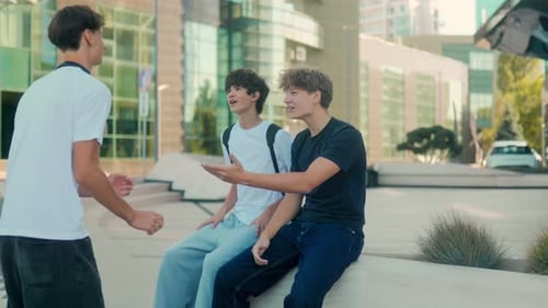 Teen Boys Talking Outside Modern Building in City