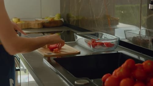 Woman Chopping Tomatoes in Modern Kitchen