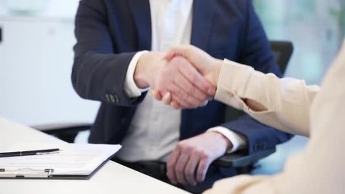 Close up. Handshake of a hr director congratulating a young woman after successful job interview.