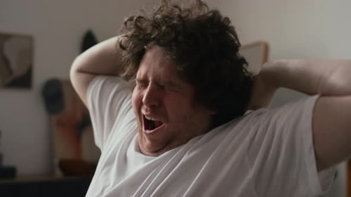 Man Stretching and Yawning in the Morning