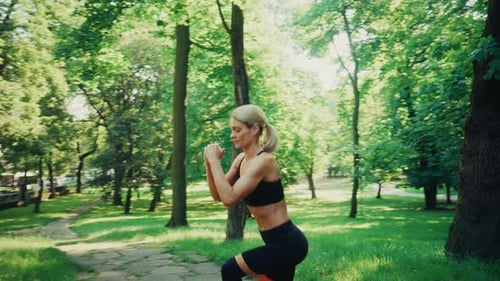 Woman Training with Resistance Band in Sunny Park