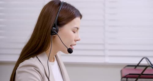 Professional Woman Working in Call Center Office Setting