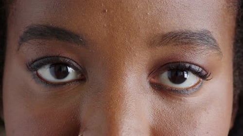 Closeup portrait of a woman with brown eyes blinking